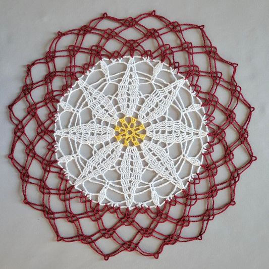White Poinsettia 16 1/2" Doily on Maroon